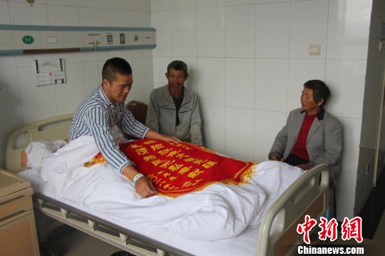 被救的李忠起、張總鳳夫婦看望受傷后的李運(yùn)飛?！⊥粲?攝